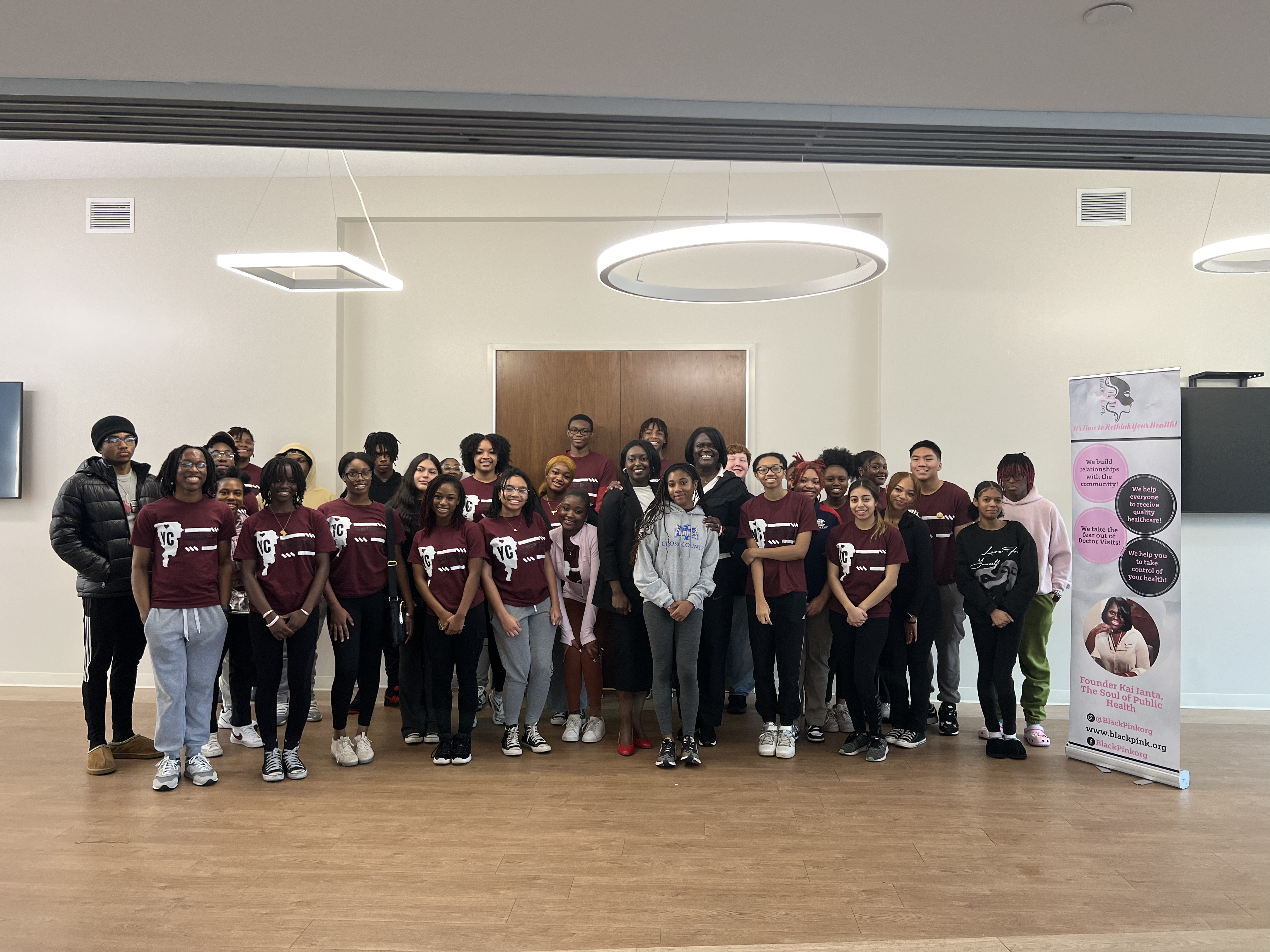 Group of people standing and posing for a photo together at the "It's Time to Rethink Your Health" event.