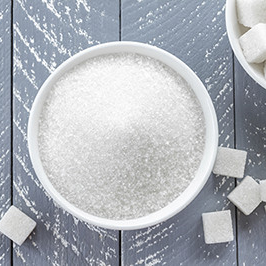 Bowl of granulated sugar and sugar cubes